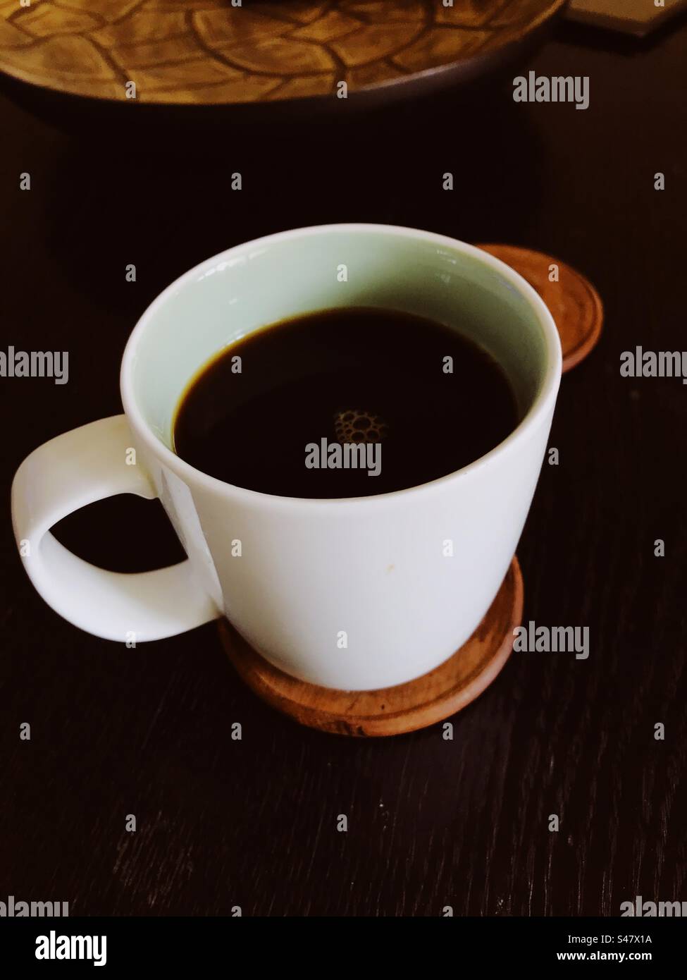 Black coffee mug on a table - Smartphone Captured Stock Image