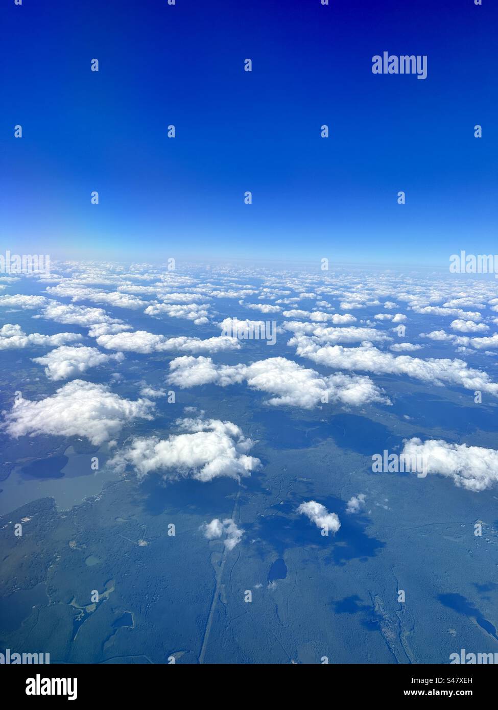 Airplane view over clouds Stock Photo