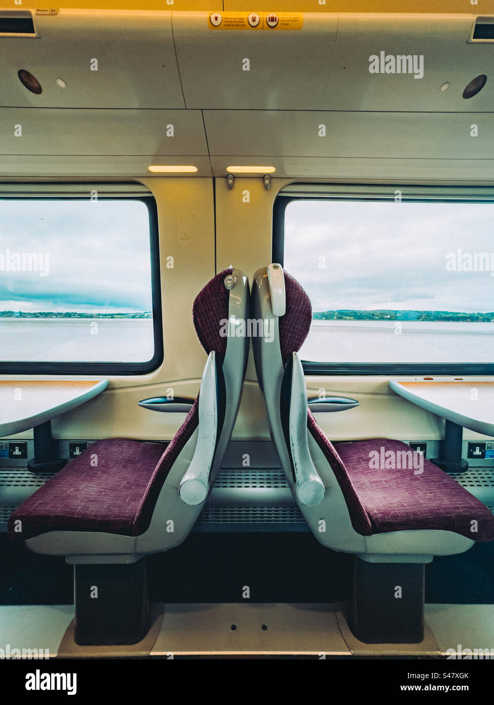 Train carriage with empty seats with a sea view - Smartphone Captured Stock Image