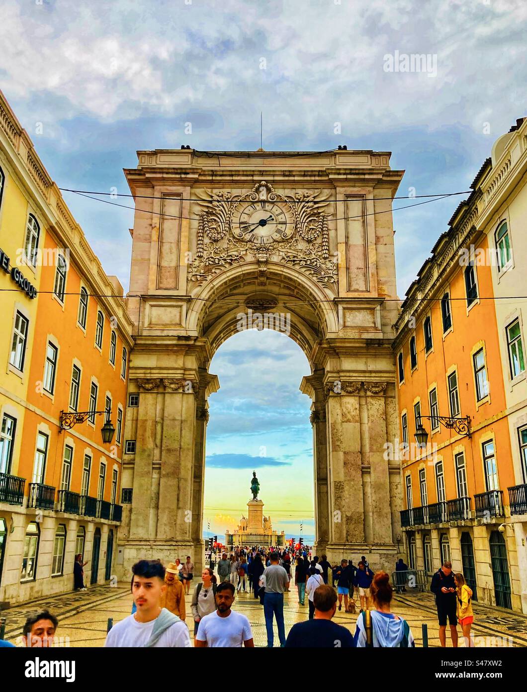 Walking through Arco da Rua Augusta archway in Lisbon Portugal at sunset looking towards Praça do Comércio - Smartphone Captured Stock Image