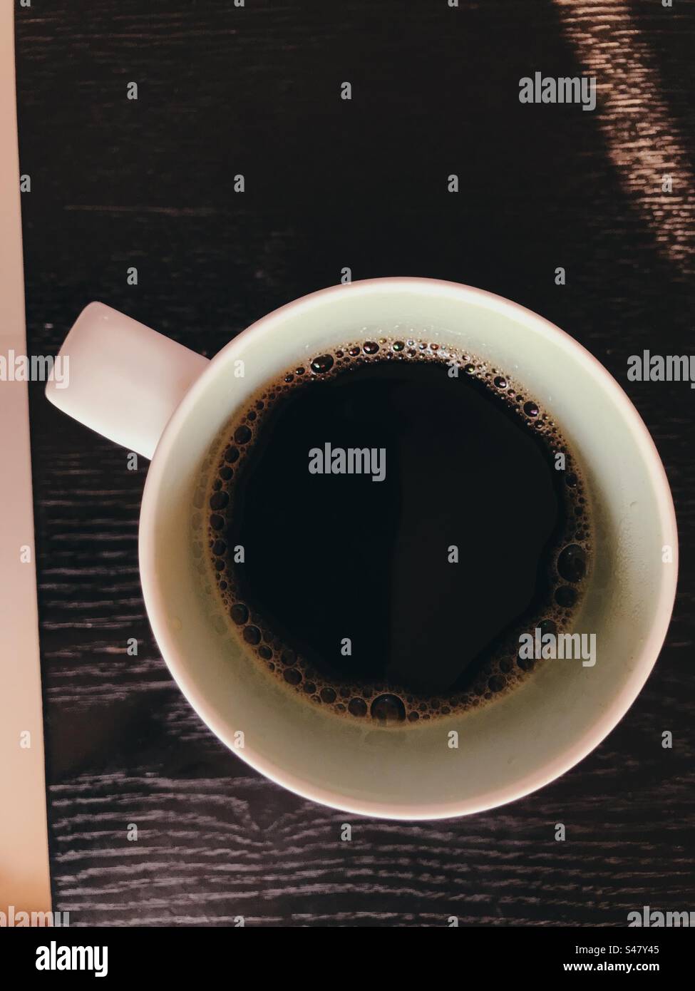 Coffee mug on top of a coffee table - Smartphone Captured Stock Image