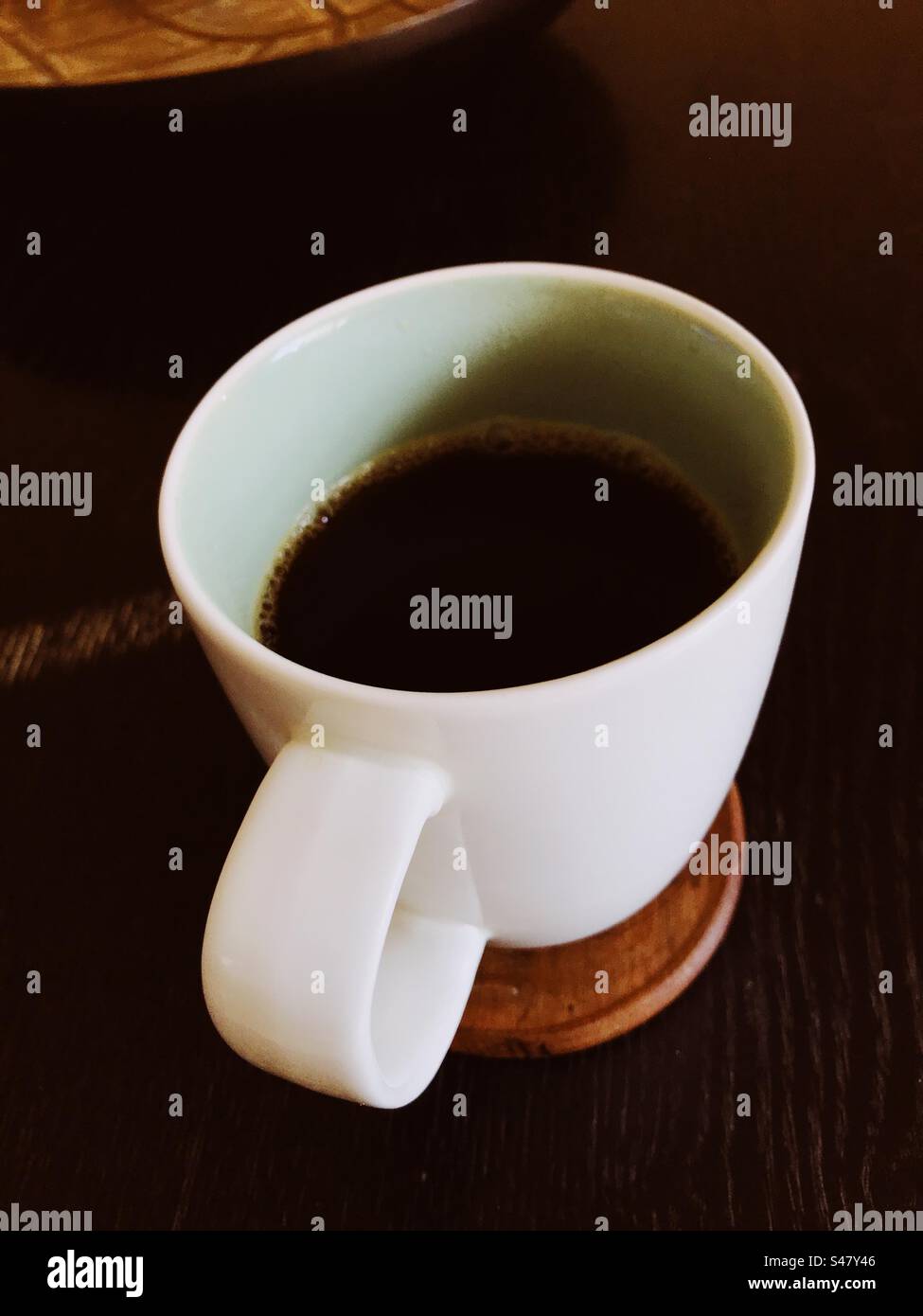 Coffee mug on top of a coffee table - Smartphone Captured Stock Image