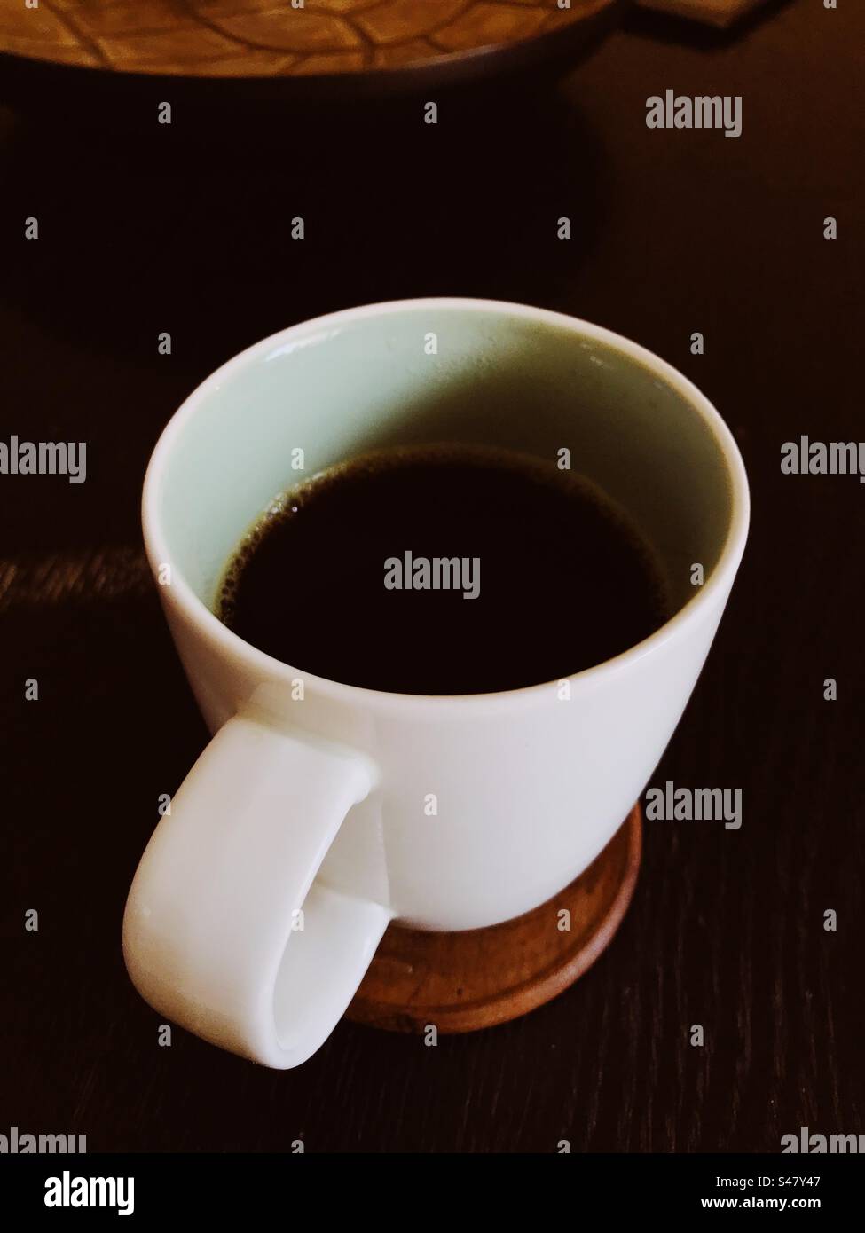 Coffee mug on top of a coffee table - Smartphone Captured Stock Image