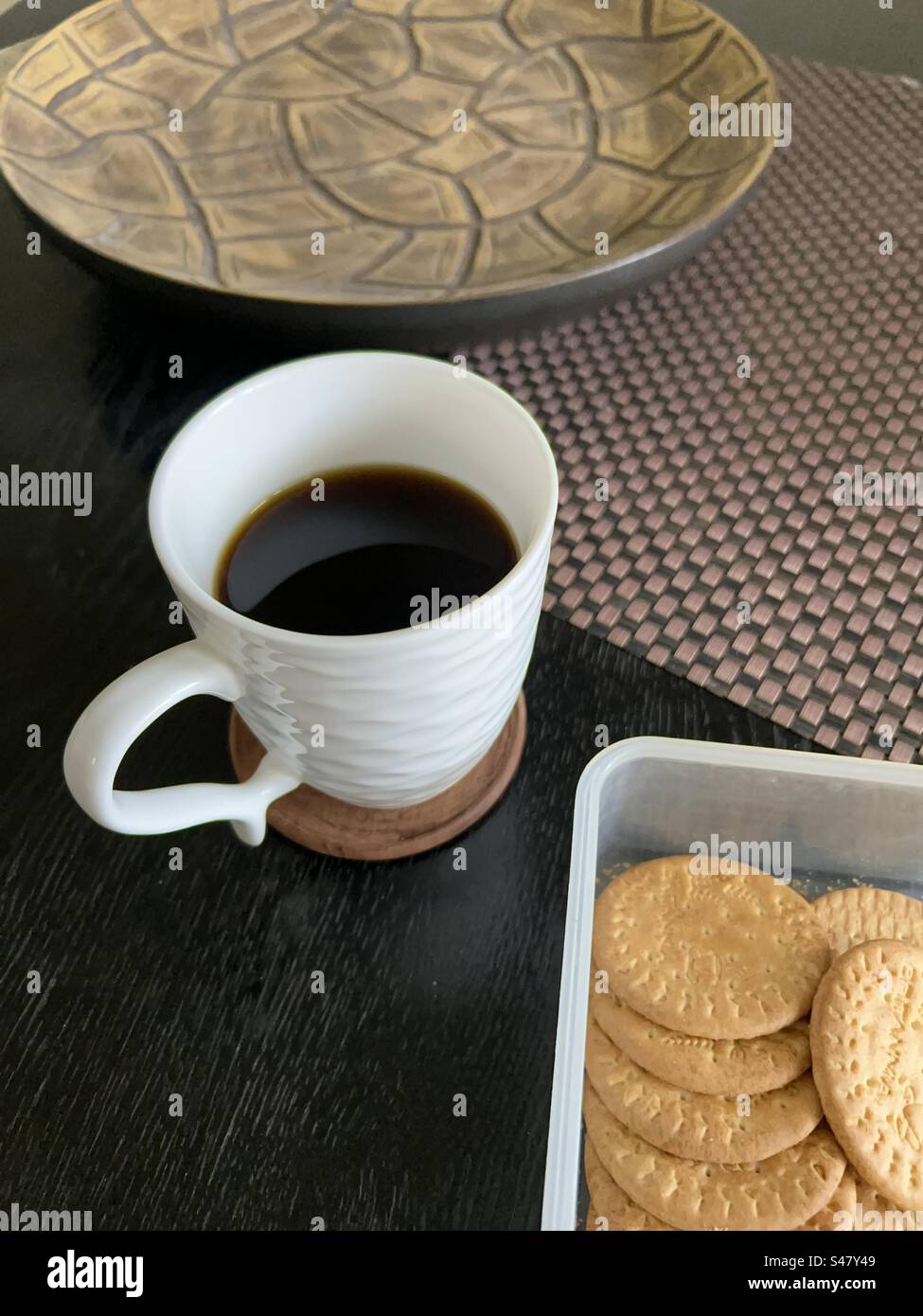 Coffee mug and biscuits on top of a coffee table - Smartphone Captured Stock Image