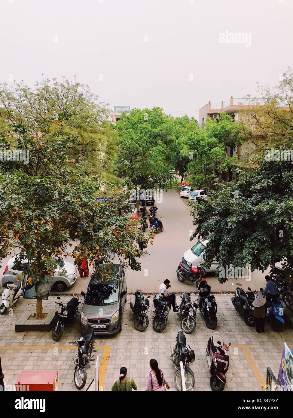 A busy street with people bikes and cars - Smartphone Captured Stock Image
