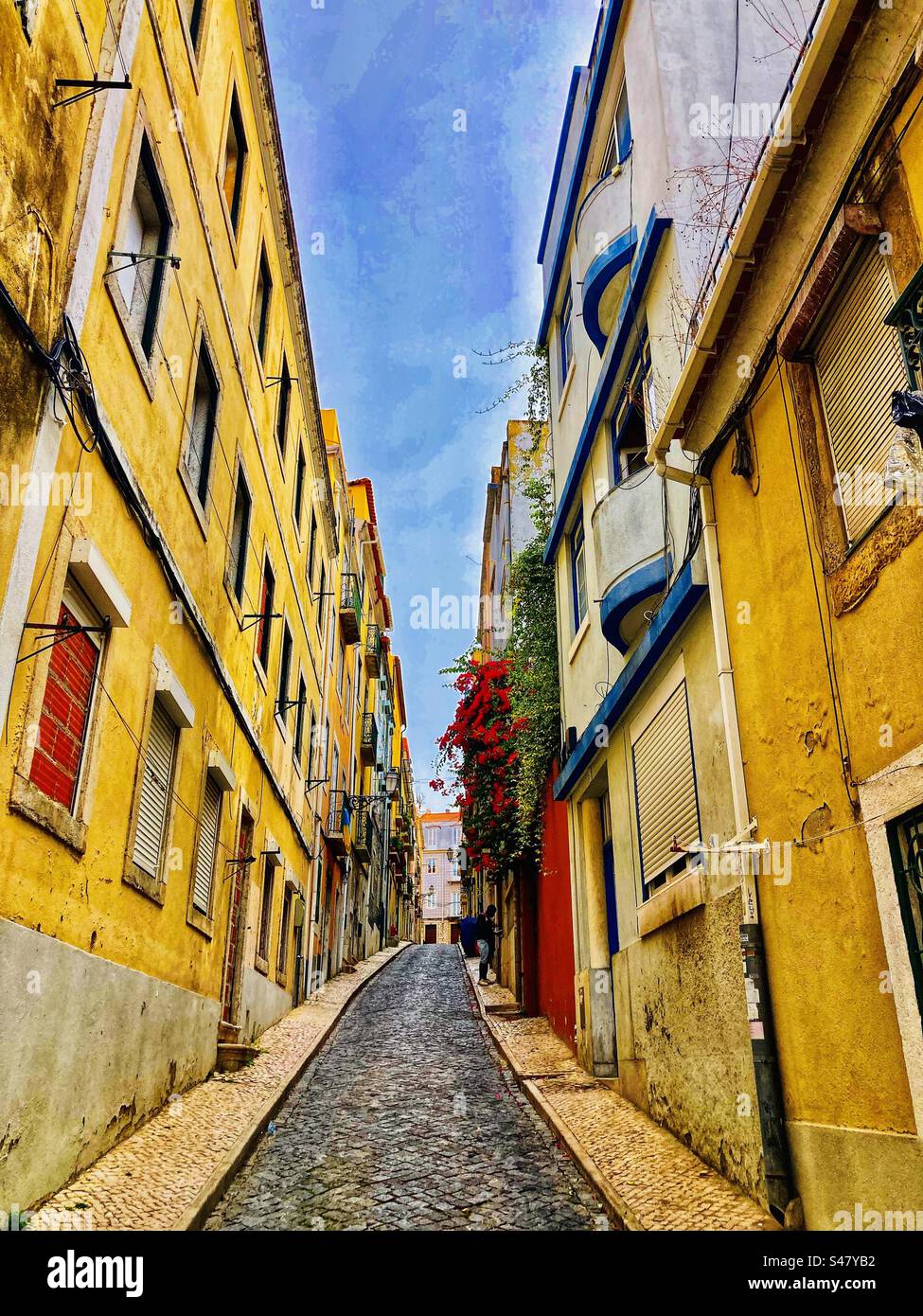 Typical Lisbon steep street with yellow houses Stock Photo