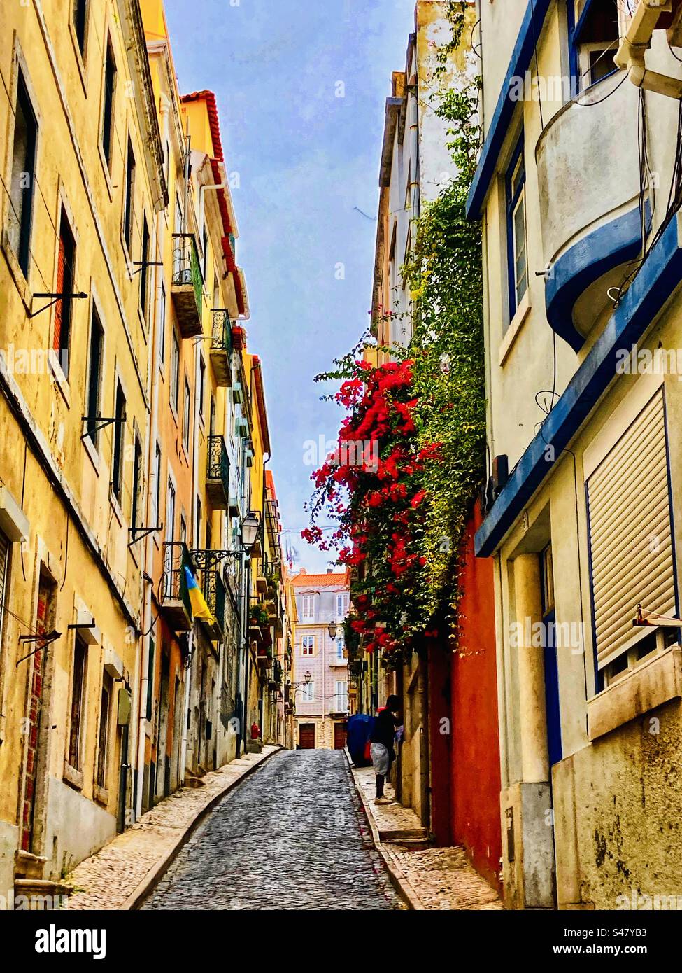 Typical Lisbon steep street with yellow house Stock Photo