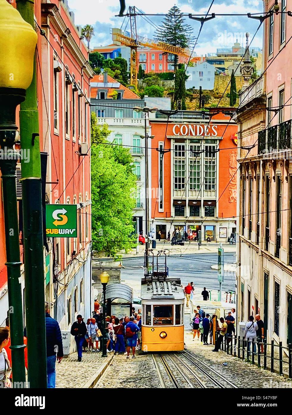 Lisbon street scene with funicular tram car and tracks down a steep street Stock Photo