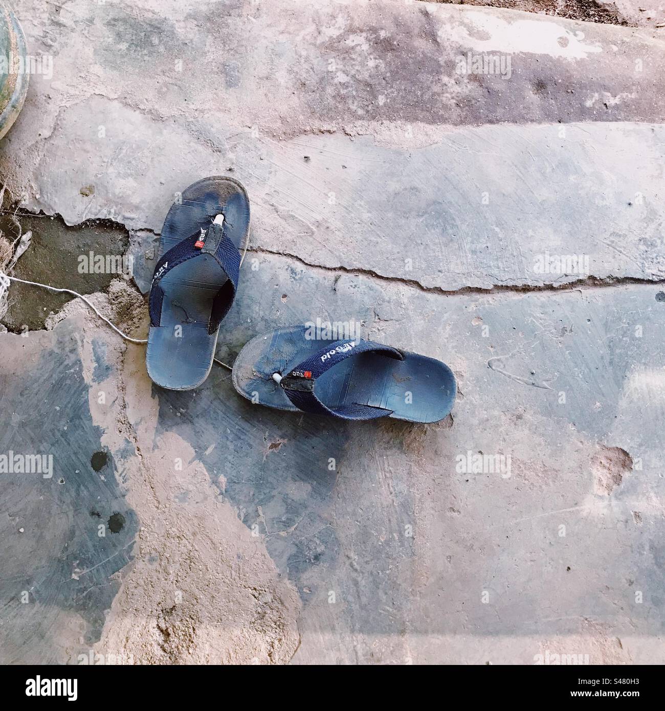 Top view of flip flops outside a temple - Smartphone Captured Stock Image