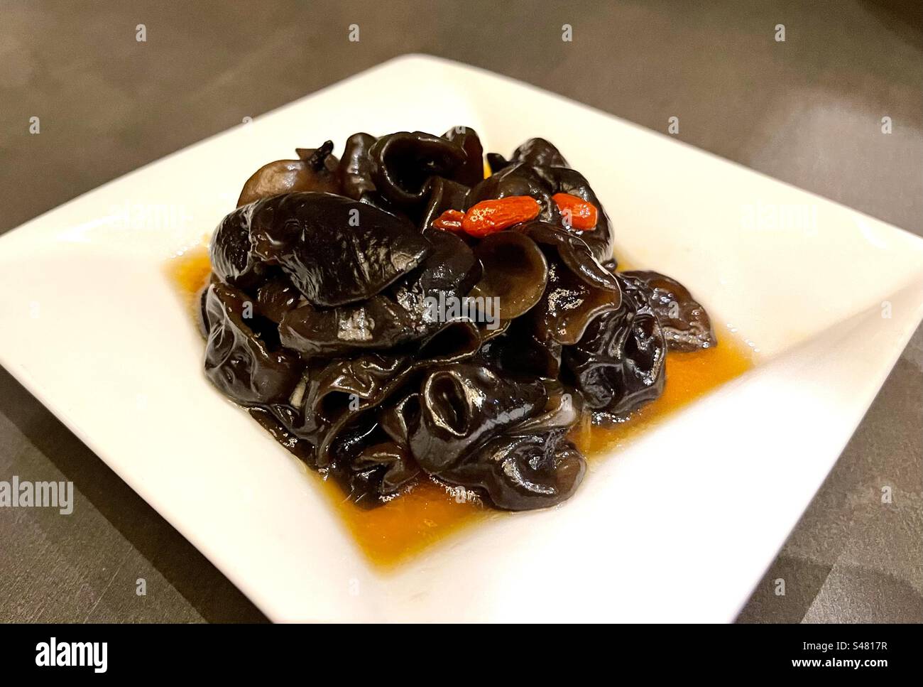 Plated Taiwanese dish of wood ear fungus, red dates, ginger strips, and vinegar dressing at Din Tai Fung restaurant Stock Photo