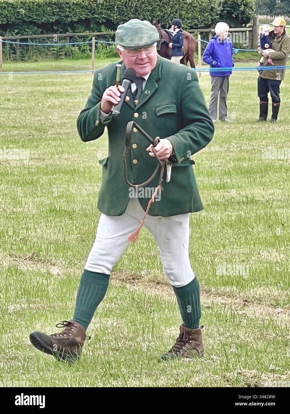 Elderly commentator with microphone at Countryside show Stock Photo