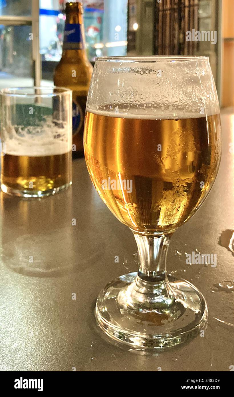 Glasses of lager on a bar terrace table in the evening - Smartphone Captured Stock Image