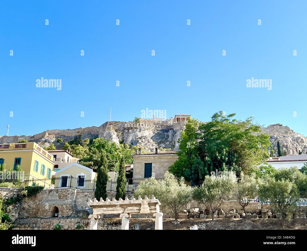 View from within the Roman Agora ruins in Athena, looking up the hills into the ancient Acropolis. - Smartphone Captured Stock Image