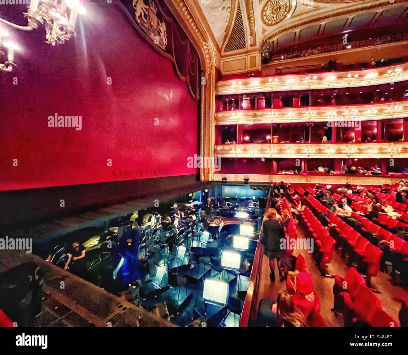 A night at the Opera - in the interval where the safety curtain is down we see the orchestra pit and stage in the Royal Opera House in Covent Garden, London. - Smartphone Captured Stock Image