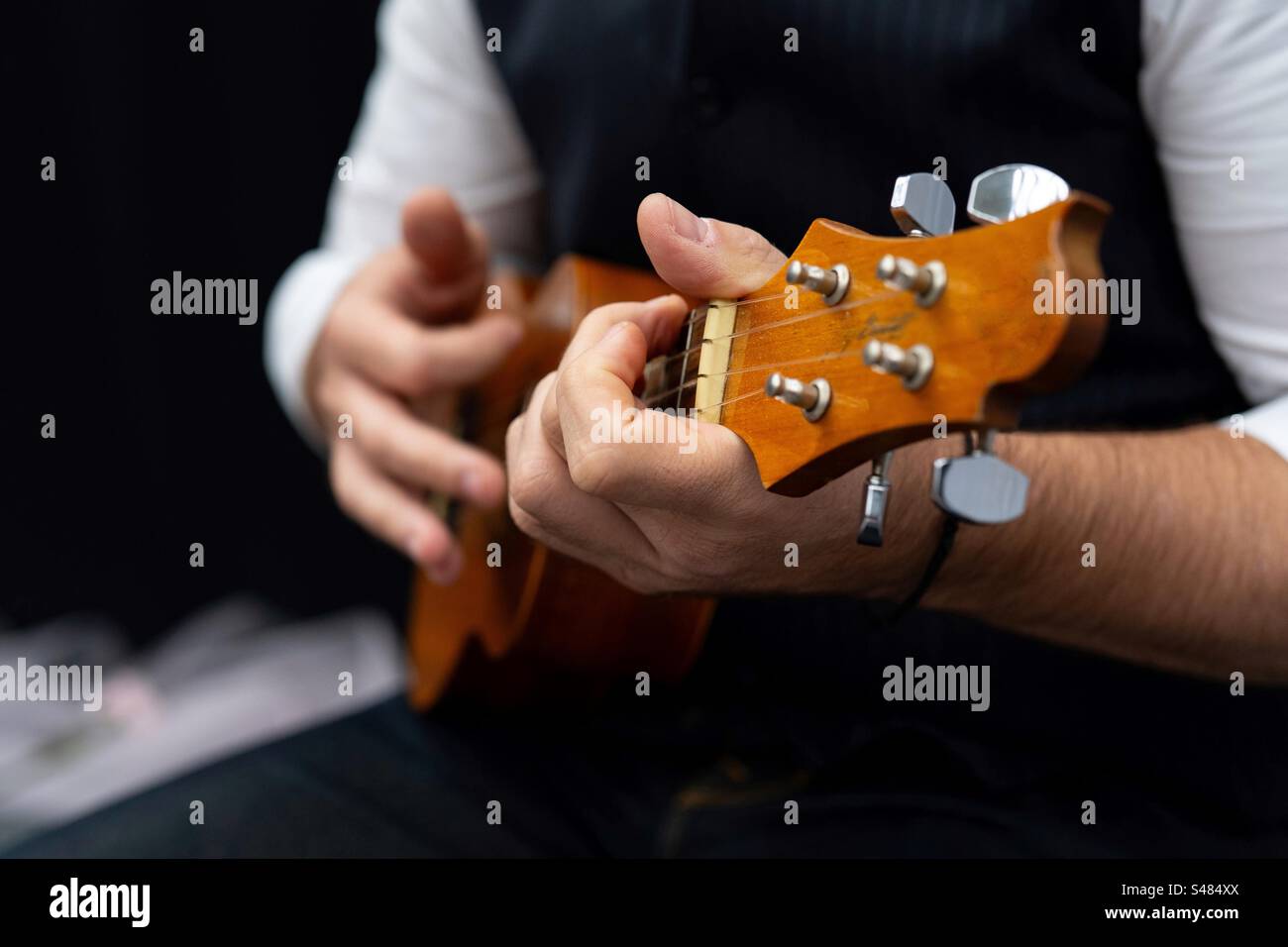 A man playing the ukulele - Smartphone Captured Stock Image