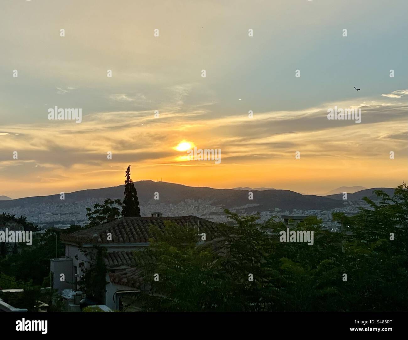 Beautiful orange sunset view from Plaka neighborhood overlooking Athens - Smartphone Captured Stock Image