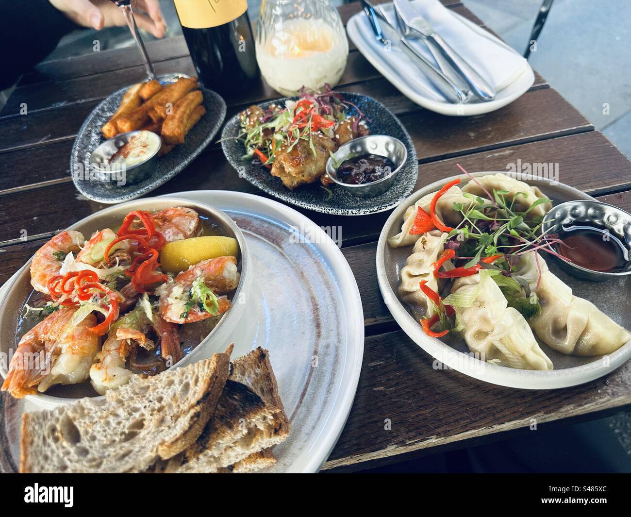 A table with small plates of food - Smartphone Captured Stock Image
