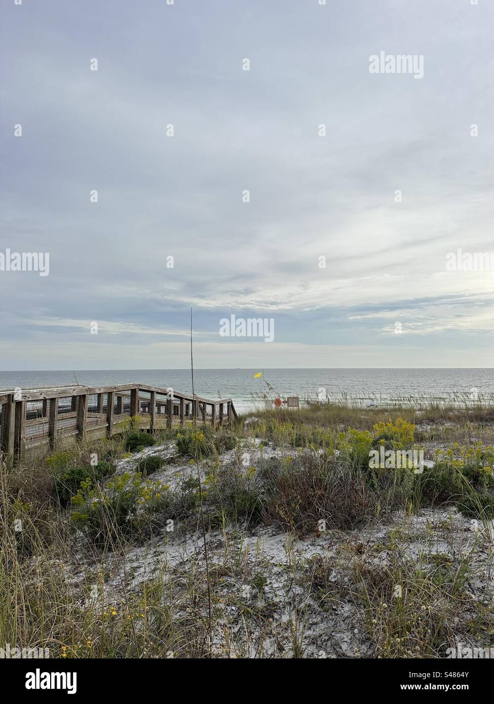 Upper view of autumn dunes with walkway and Gulf of Mexico water view ...