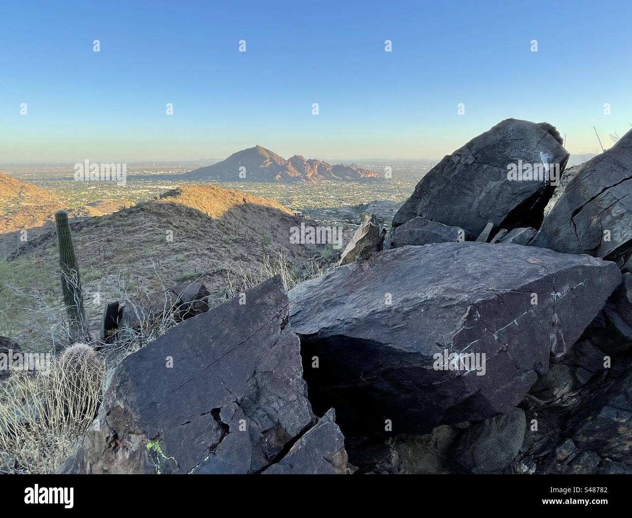 Camelback mountain with setting - Giant Boulders With Desert Varnish Camelback Mountain With Setting Sun Glow View From Hiking Trail Banded Blue And Orange Sunset Phoenix Mountains Preserve Arizona S48782 
