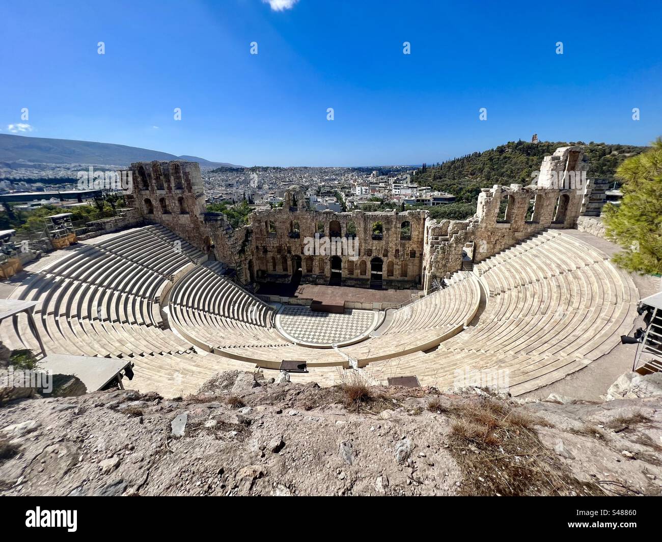 The Odeon of Herodes Atticus is an ancient amphitheater in the Acropolis that today is still host to live theater performance. Stock Photo