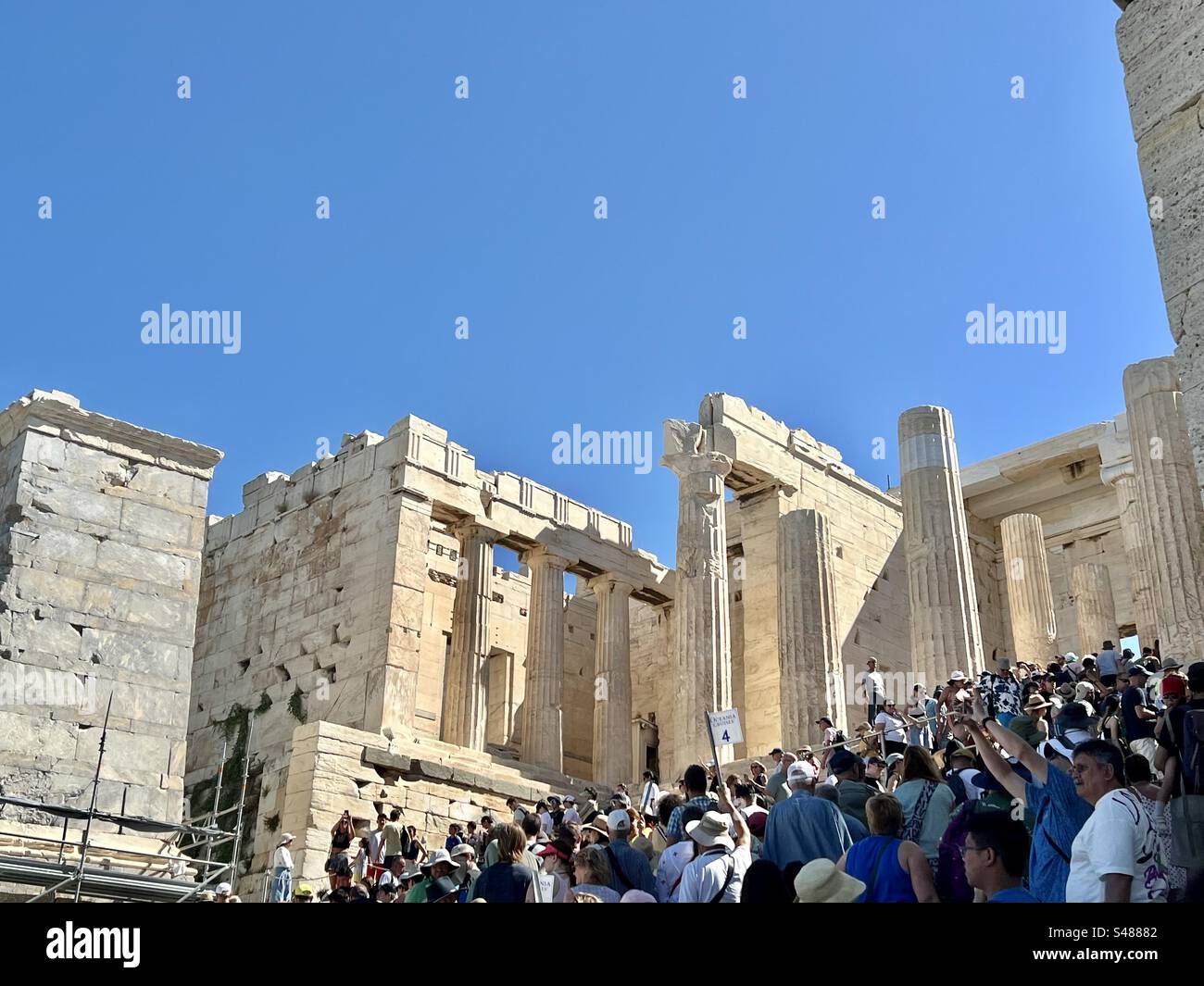 Crowds on winding uphill path beyond main Acropolis entrance, Beule Gate, continuing to the Propylaia monumental gateway, passing Monument of Agrippa, Temple of Athena and Shrine of Athena - Smartphone Captured Stock Image Crowds on winding uphill path beyond main Acropolis entrance, Beule Gate, continuing to the Propylaia monumental gateway, passing Monument of Agrippa, Temple of Athena and Shrine of Athena - Smartphone Captured Stock Image