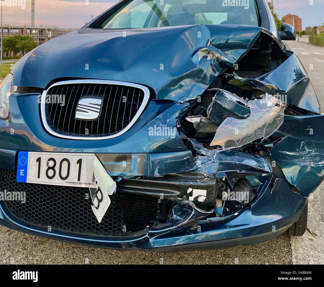 Crash damaged blue Seat car with destroyed front parked in the street Cueto Cantabria Spain - Smartphone Captured Stock Image