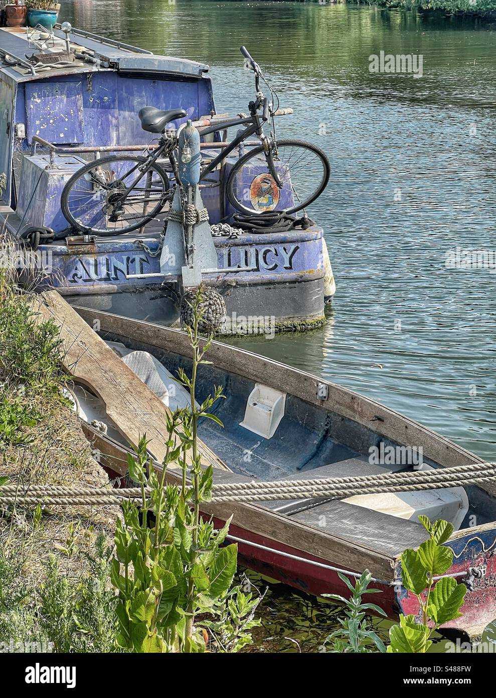 Residential narrowboat with bicycle and dinghy Stock Photo Alamy