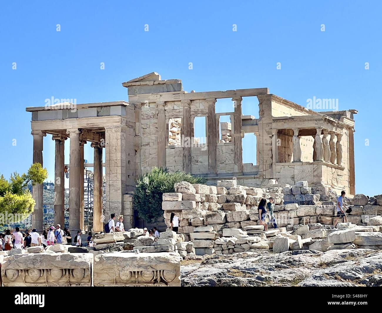 Tourists at the Erchtheion on a sunny August day at Acropolis Hill in Athens - Smartphone Captured Stock Image
