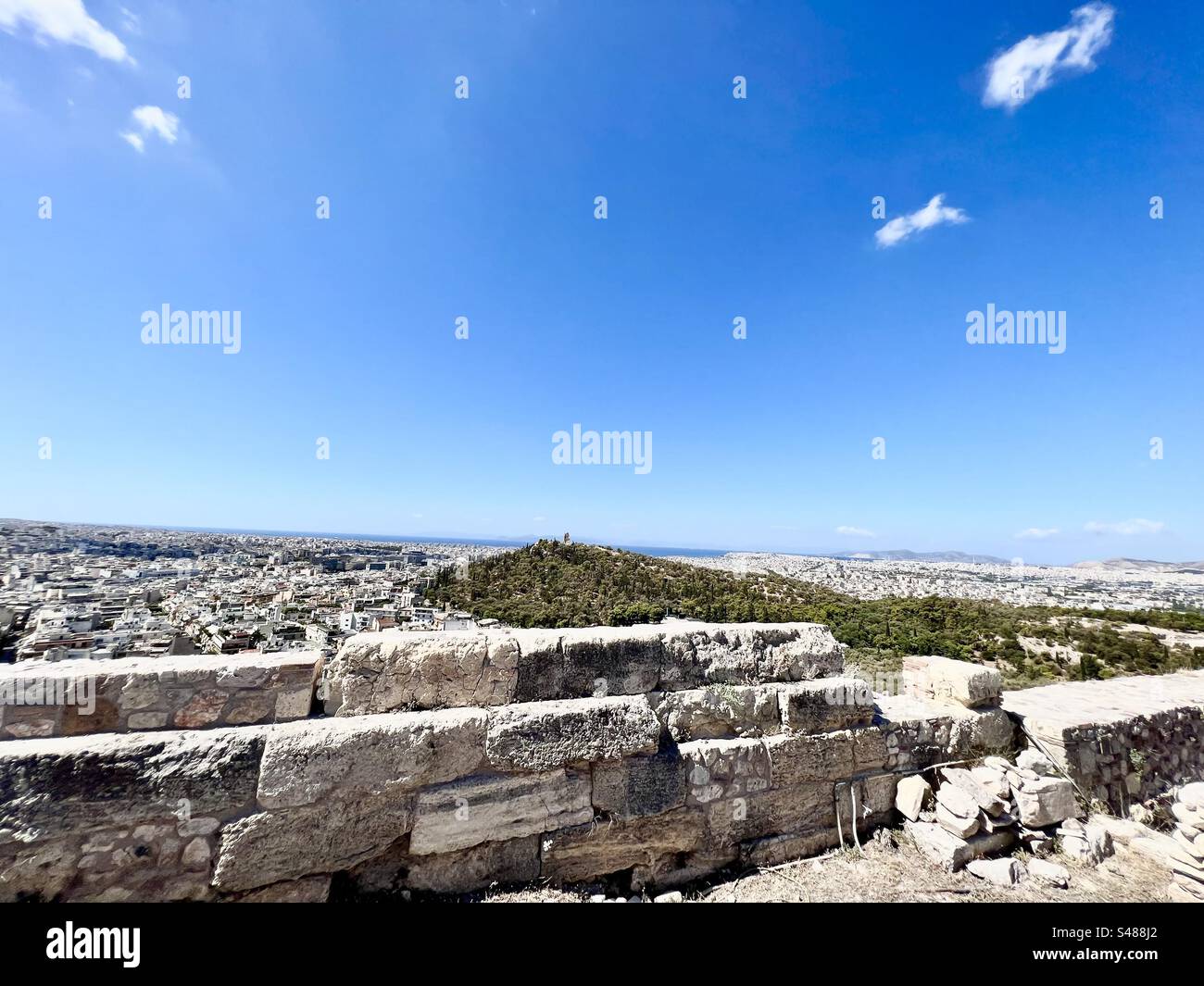 City of Athens and Filopappou Hill viewed from atop Acropolis Hill ancient archaeology site - Smartphone Captured Stock Image
