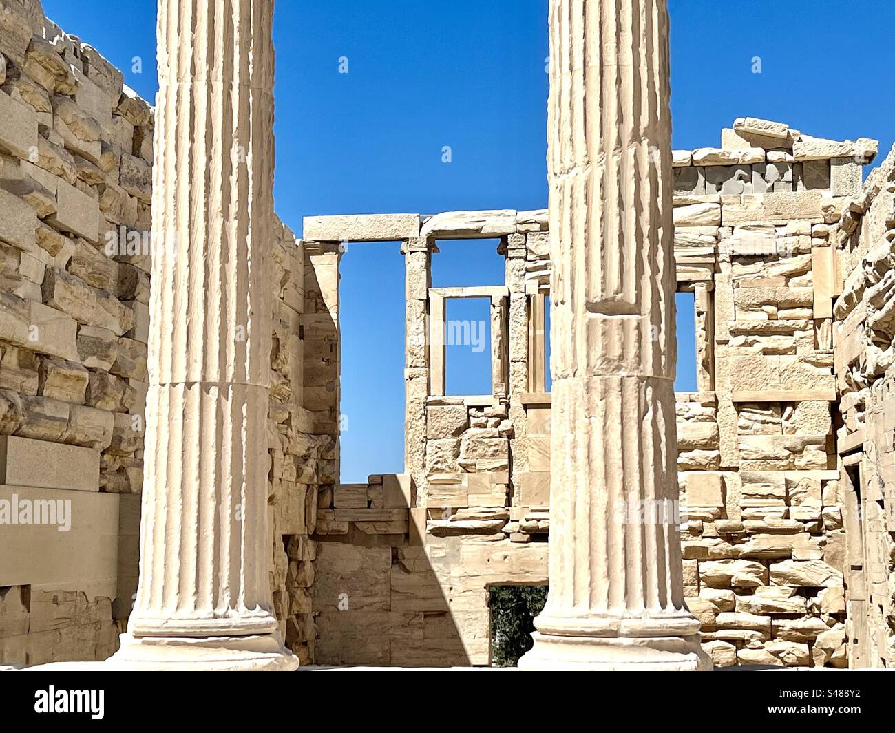 Columns and window frames of the east side of  the Erechtheion, an Ionic temple on Acropolis Hill. - Smartphone Captured Stock Image