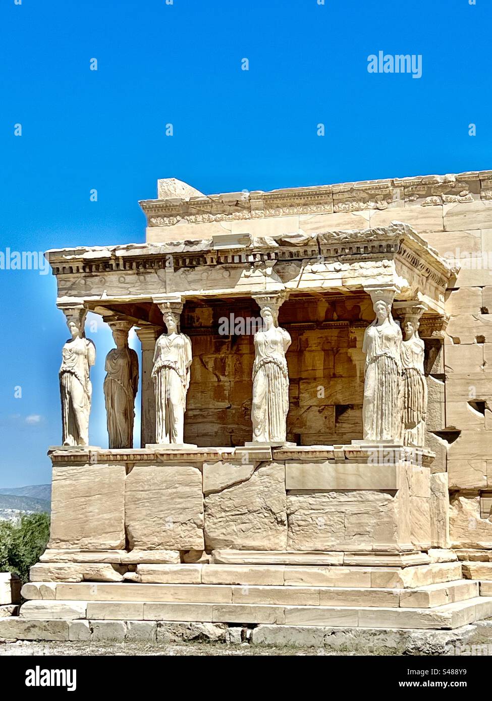 The Porch of the Caryatids with columns of female maiden figures, detailed and ornate ruins of Acropolis Hill archaeological site in Athens - Smartphone Captured Stock Image
