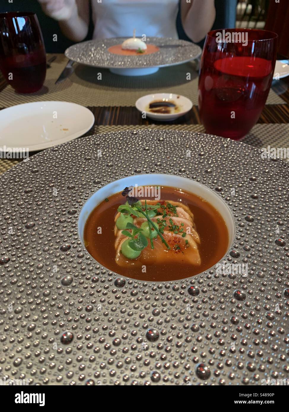 Closeup image of a fresh salmon, guacamole and yuzu starter at a restaurant in Dubai, UAE - Smartphone Captured Stock Image
