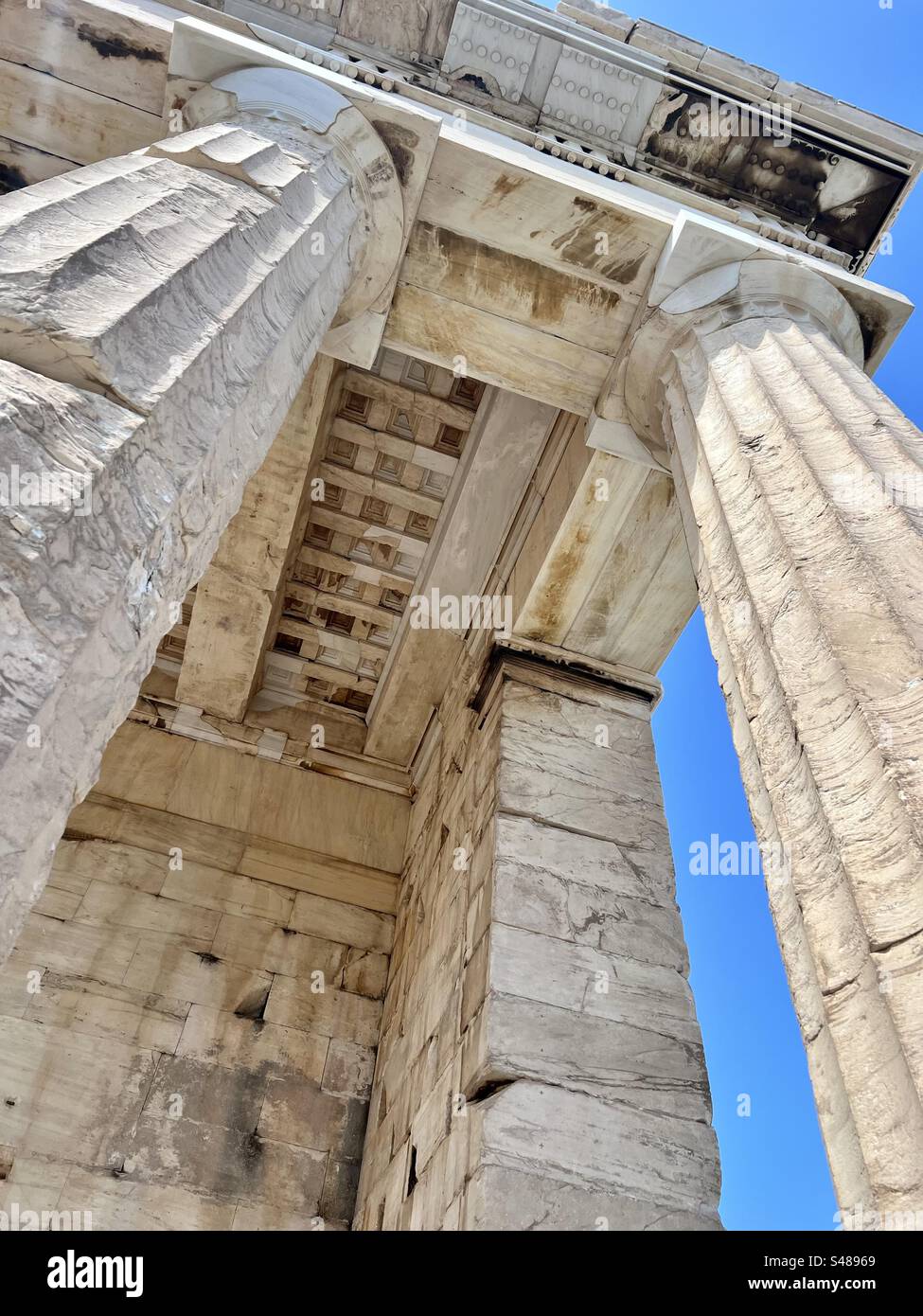 Looking up at details of the ancient gateway to the Acropolis, Propylaia, in Athens - Smartphone Captured Stock Image