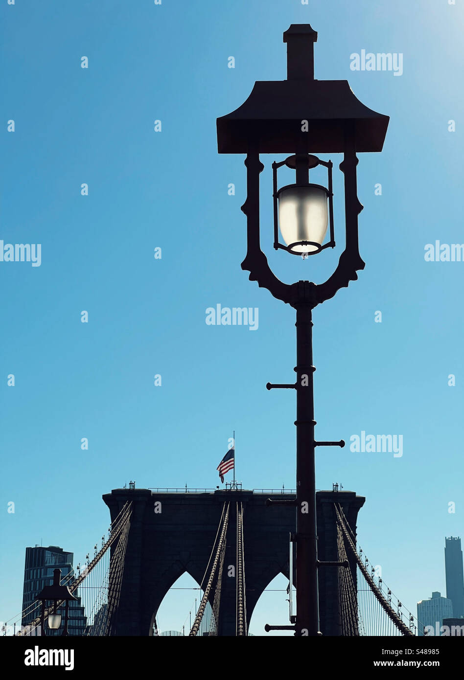 Backlit lamp on Brooklyn Bridge. New York Stock Photo