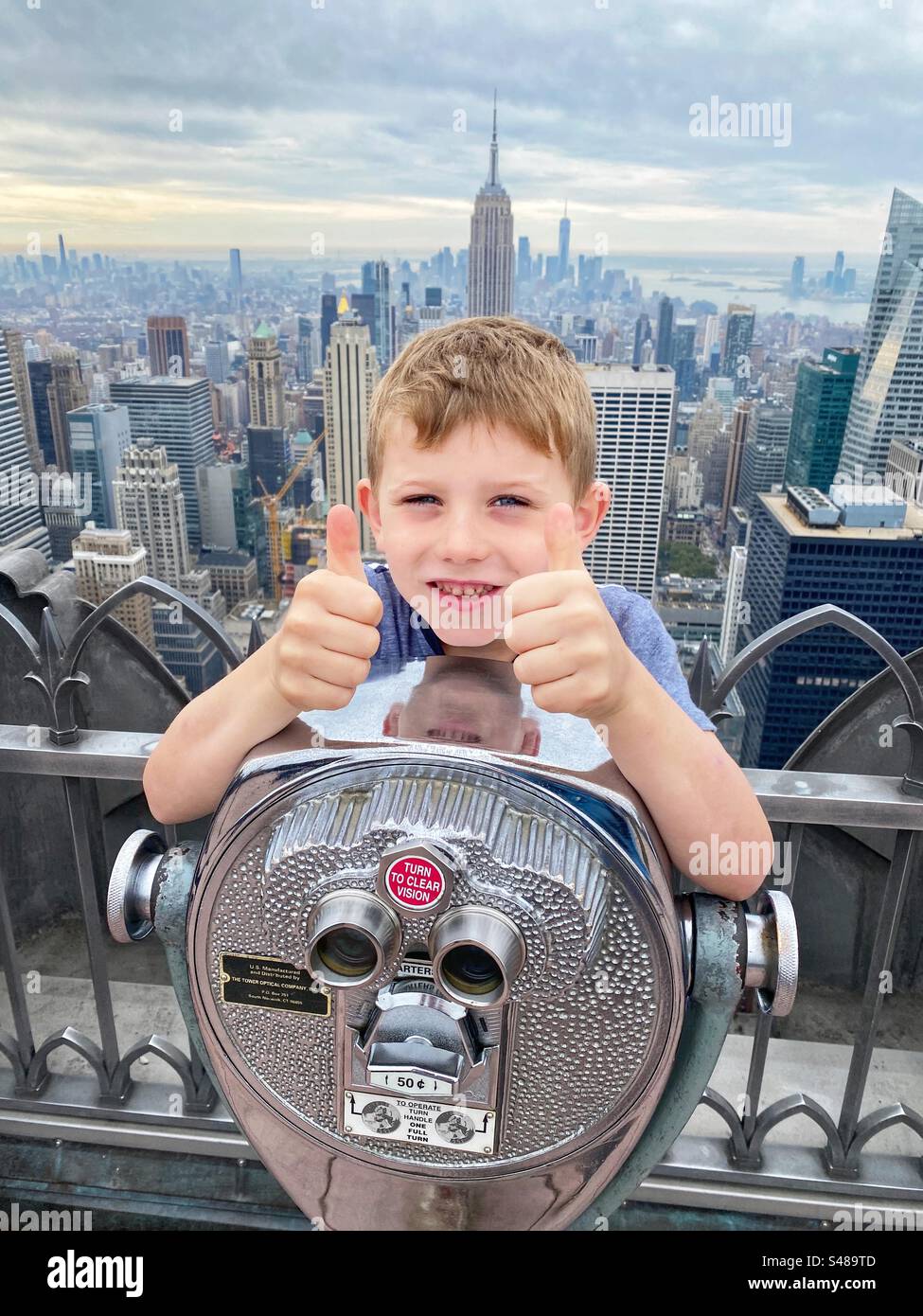 Seven year old boy at the top of the Rockefeller building, New York City, United States of America - Smartphone Captured Stock Image