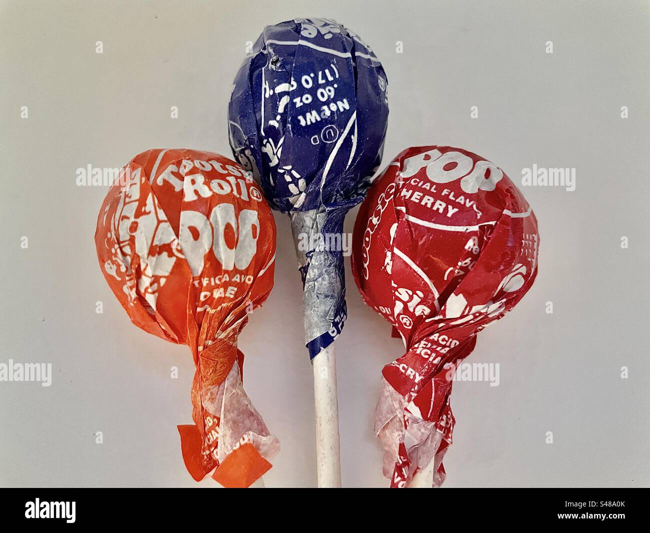 Tootsie Pop suckers (orange, grape and cherry flavors) as still life. - Smartphone Captured Stock Image