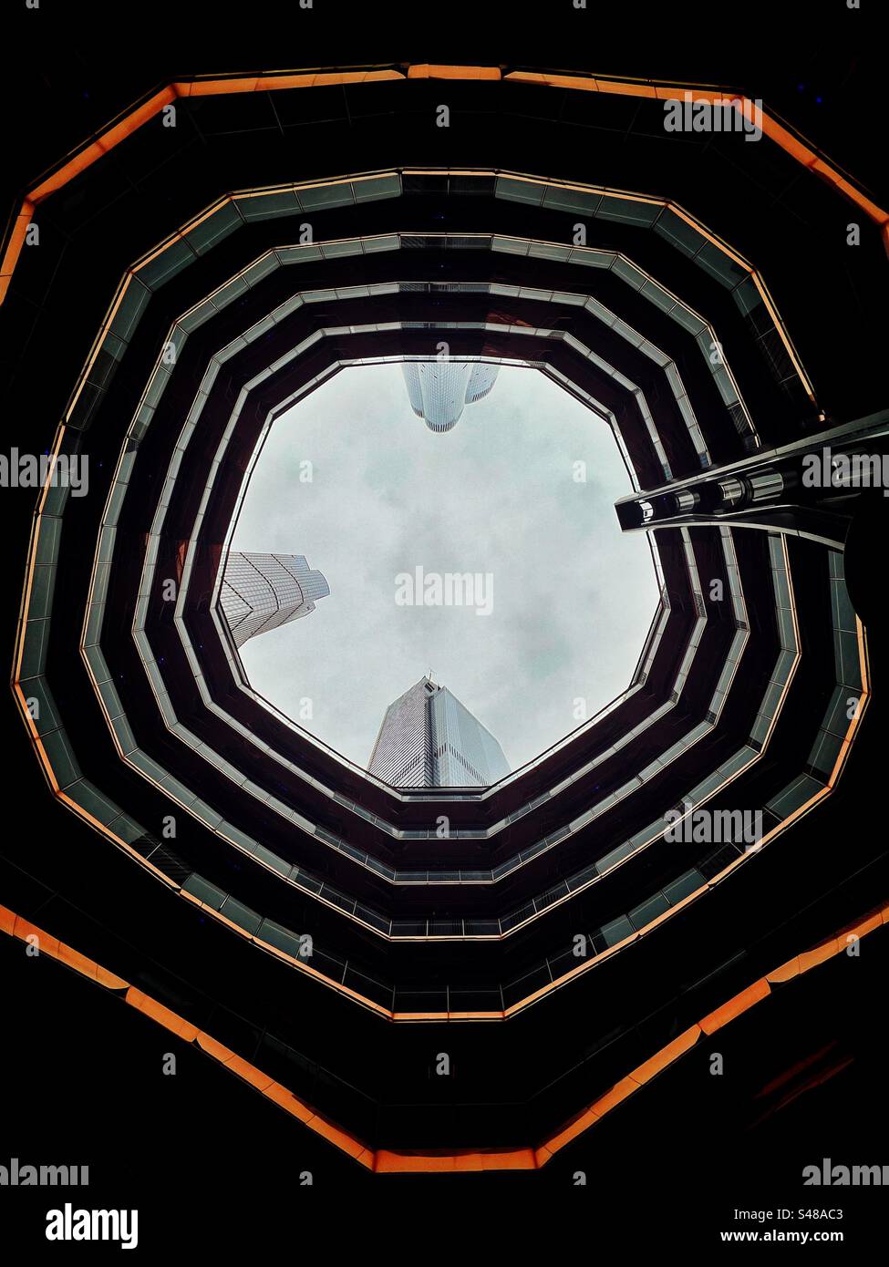 Looking up through the Vessel artwork in Hudson Yards development, New York. It comprises 16 stories and 154 flights of steps   It was designed by Thomas Heatherwick. Stock Photo