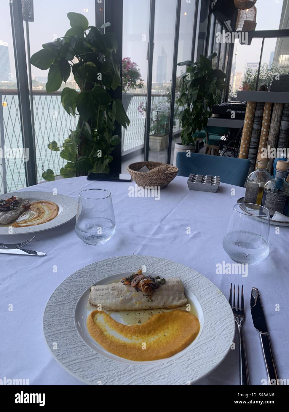 Panseared sea bass fillet with carrot mash and herbmarinated candied