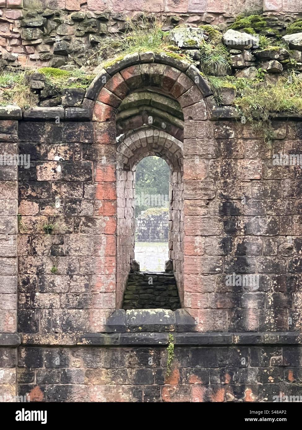 Fountains abbey window upon window looking through multiple arches windows Stock Photo