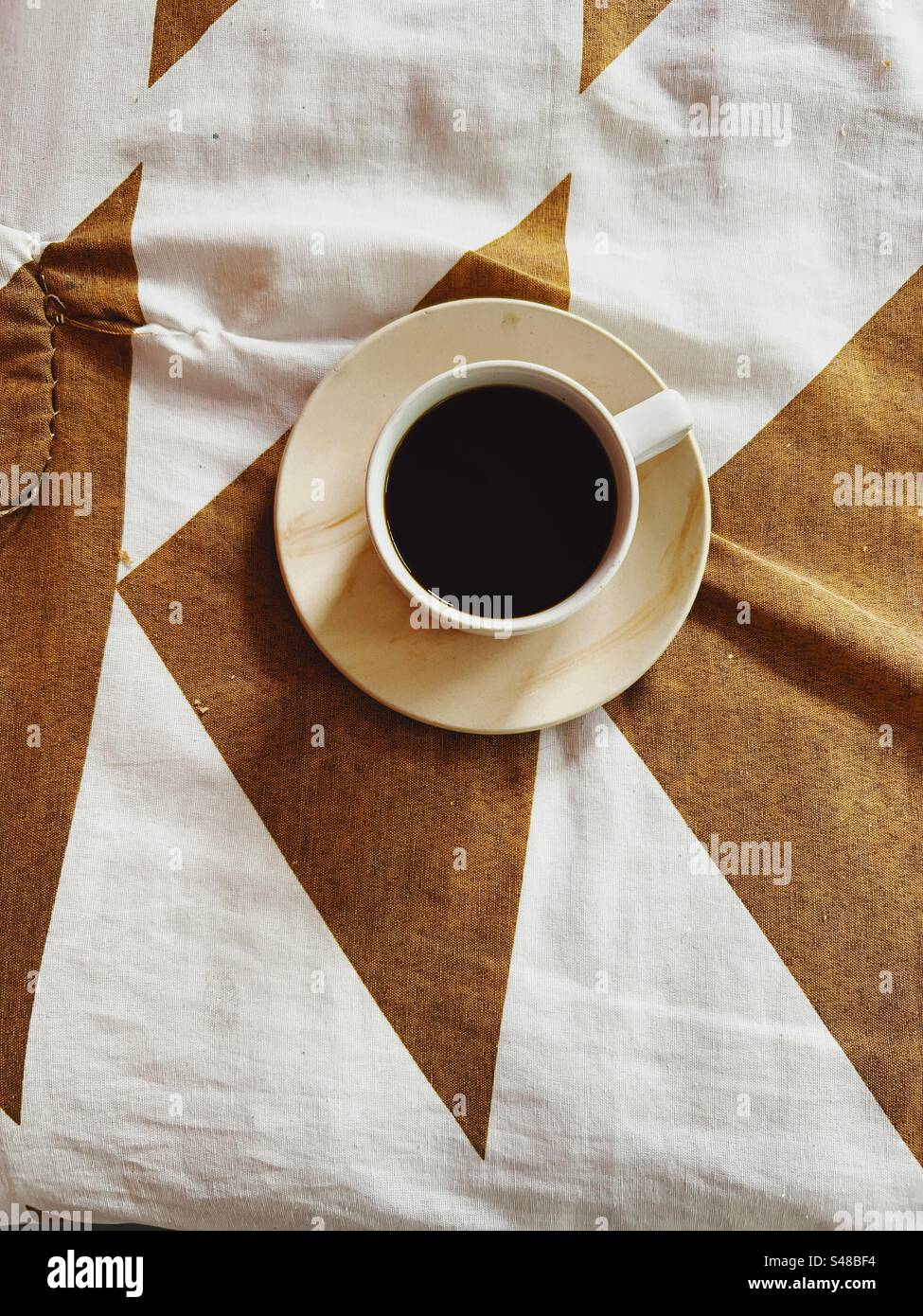 Top view of a black coffee cup and saucer - Smartphone Captured Stock Image
