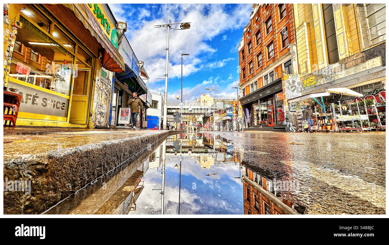 Peckham High street reflections in a puddle. Stock Photo