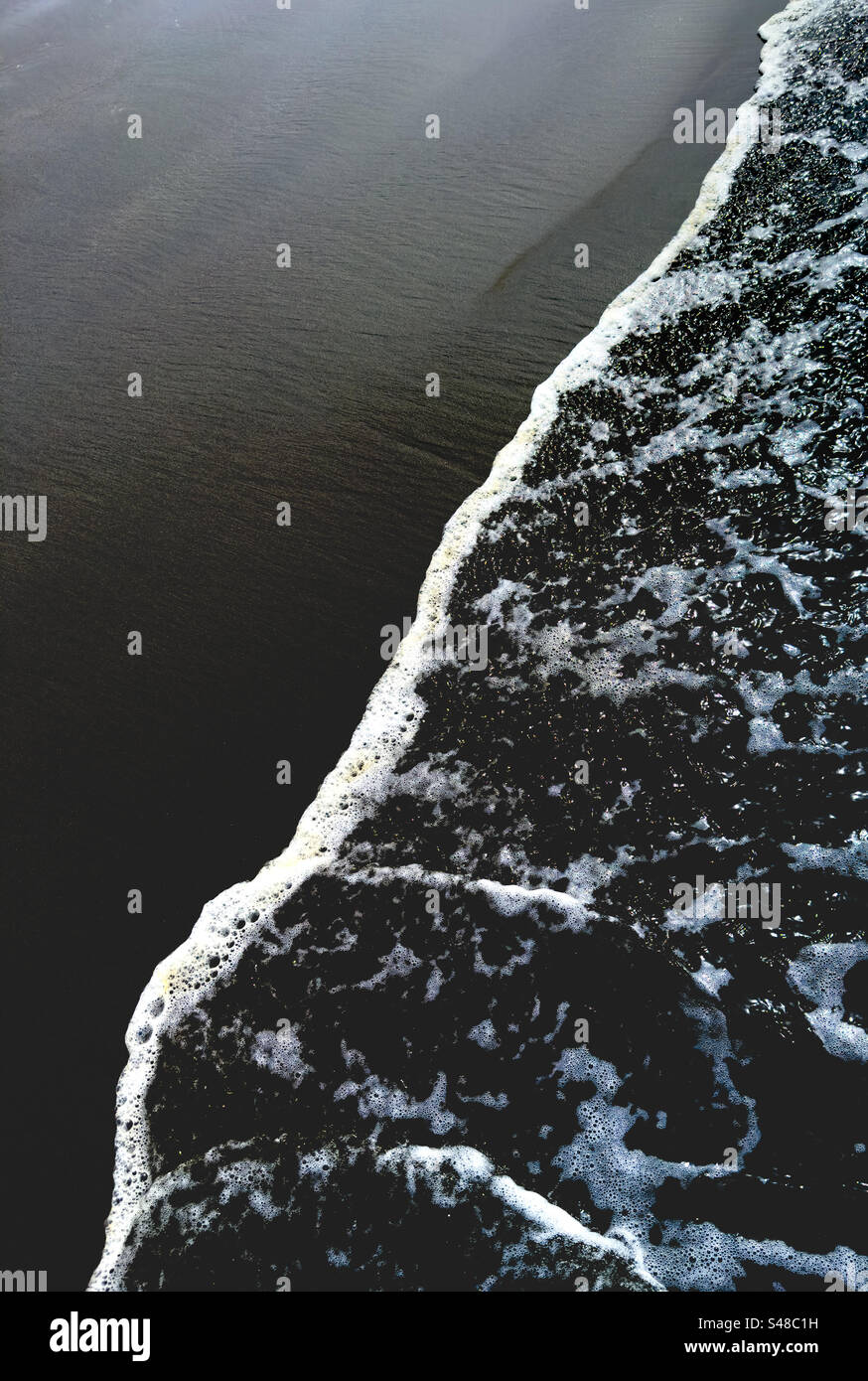 Incoming tide with water line on sandy beach - Smartphone Captured Stock Image