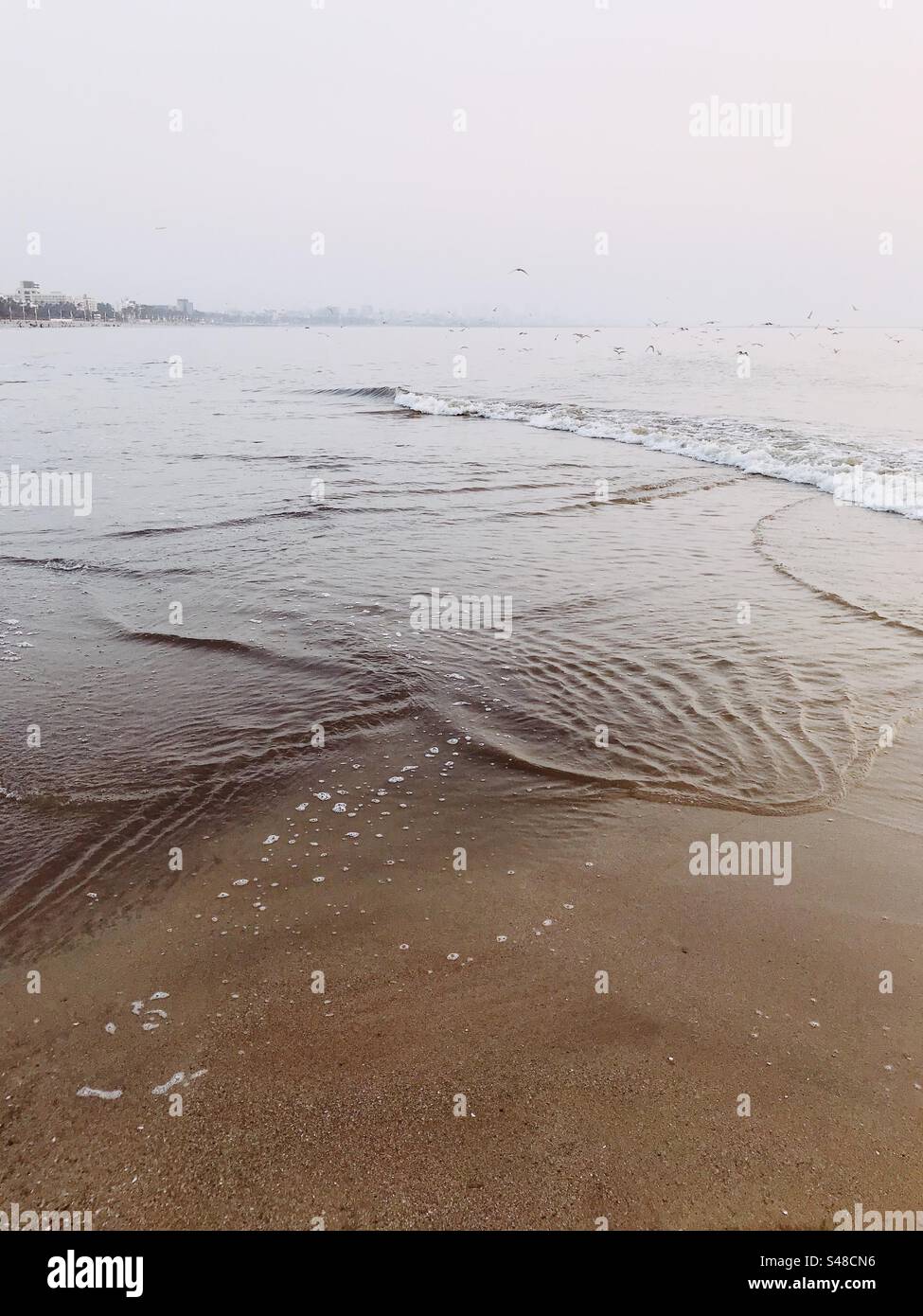 Ocean tides forming patterns on Versova beach in Mumbai - Smartphone Captured Stock Image