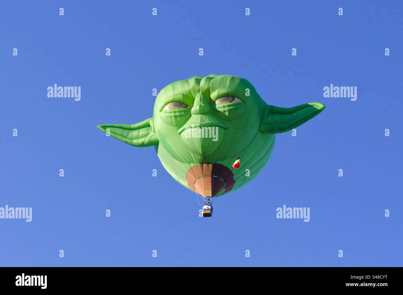 Hot air balloon shaped like Yoda flying in the balloon fiesta in Albuquerque New Mexico Stock Photo