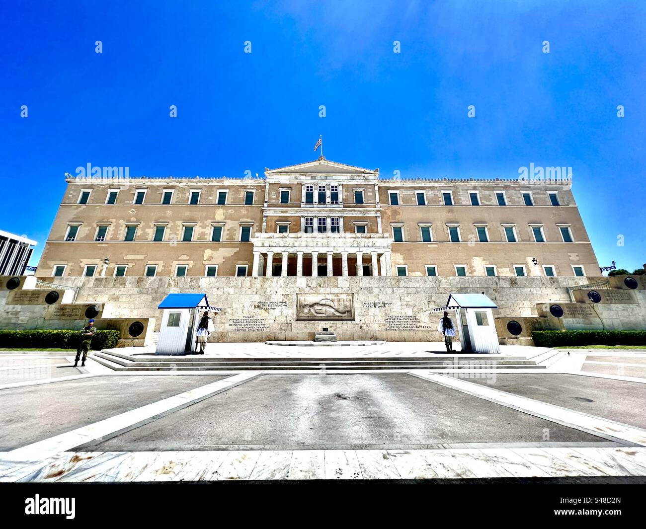 Evzones stand guard outside the Greek Presidential Palace and Tomb of the Uknown Soldier memorial in Athens. - Smartphone Captured Stock Image