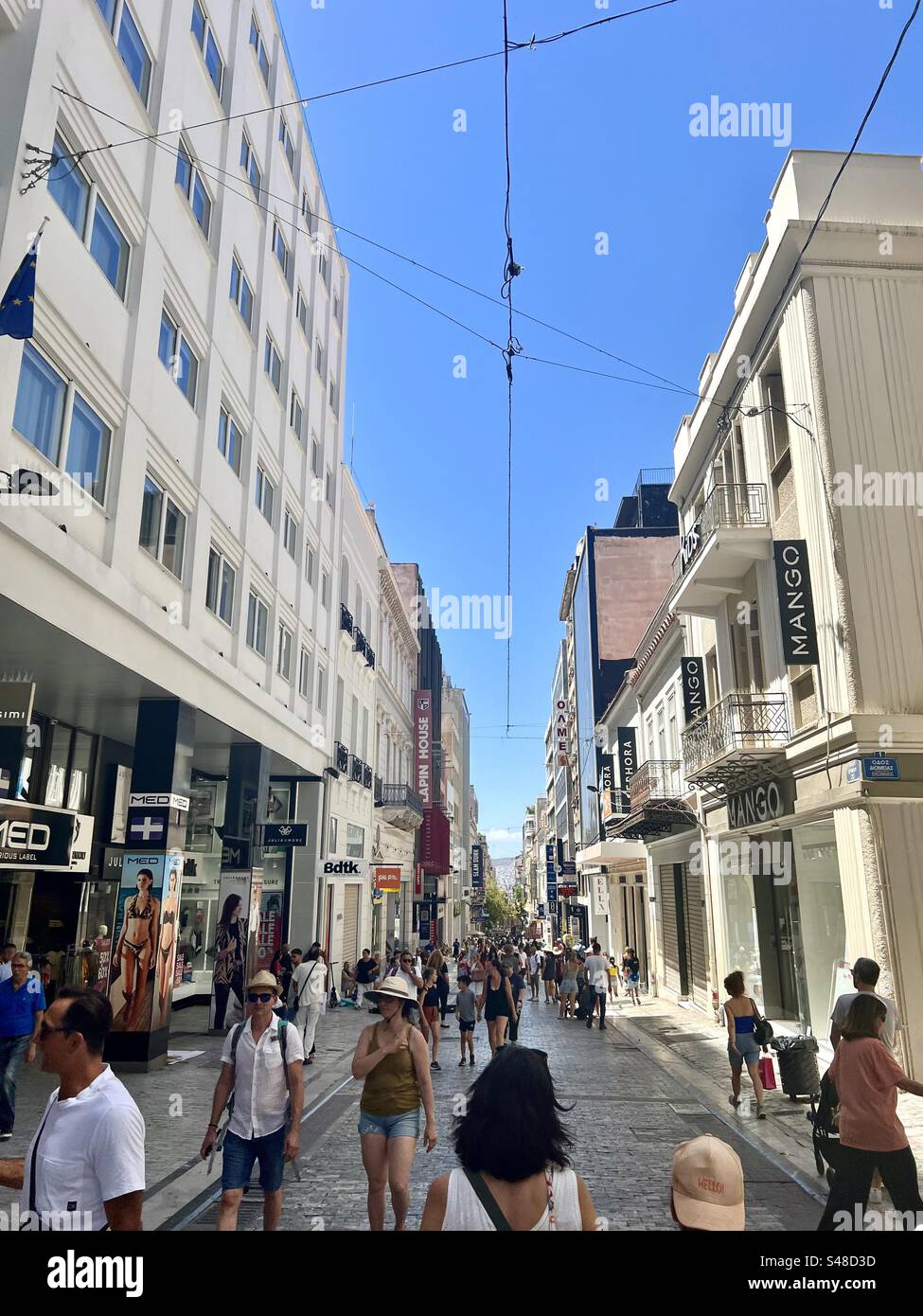 People walking along Ermou Street, known as a main street for shopping, in the Syntagma district of Athens. - Smartphone Captured Stock Image
