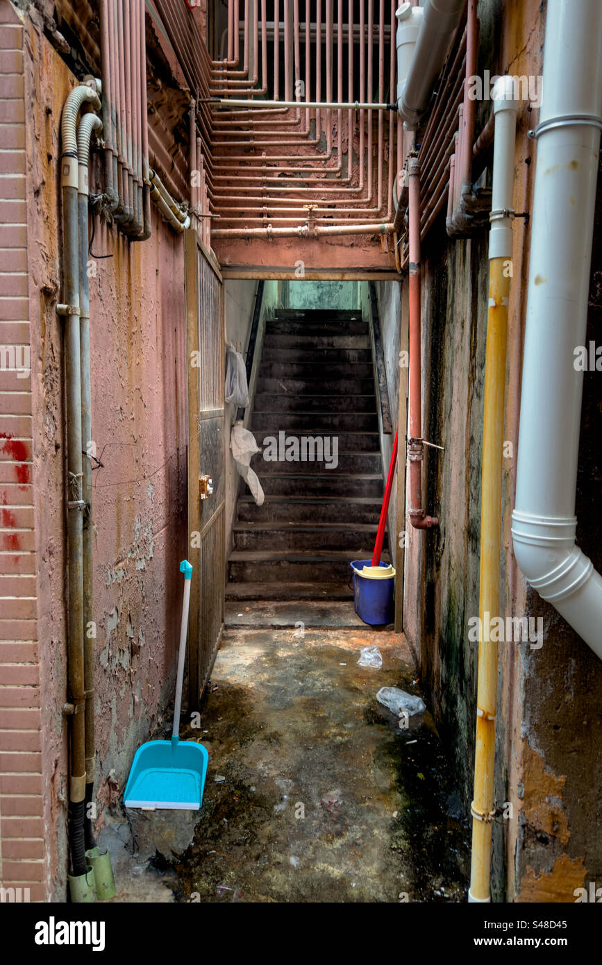 Back entry in alleyway to old concrete building in the crowded Mong Kok district of Hong Kong - Smartphone Captured Stock Image