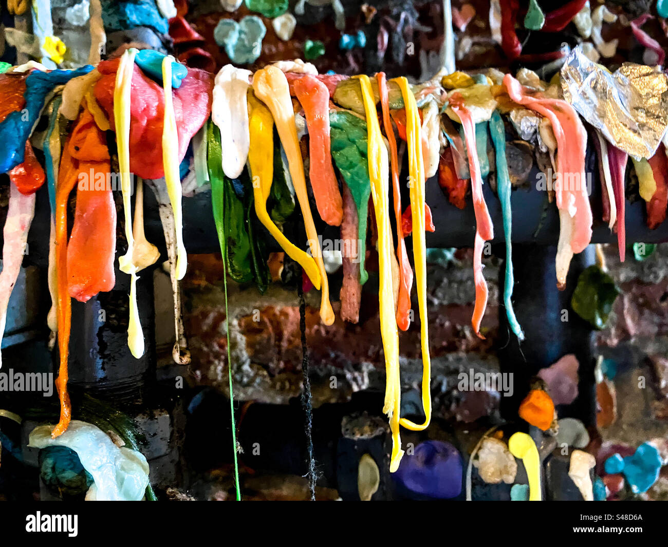 Gooey gum hanging from a ledge in the iconic and somewhat unhygienic