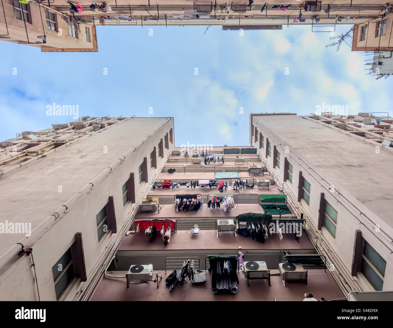Upward view of old densely packed residential buildings in Hong Kong - Smartphone Captured Stock Image