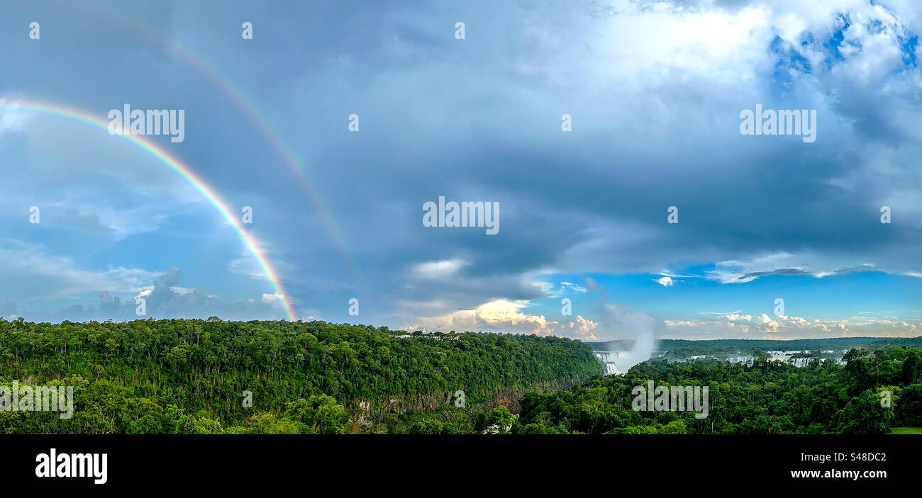 Double rainbow over Iguazu falls National park with falls in the distance on the right - Smartphone Captured Stock Image
